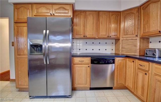 kitchen featuring stainless steel appliances and tasteful backsplash