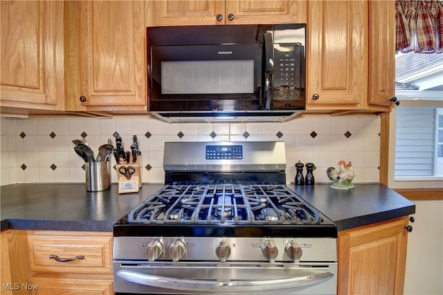 kitchen with gas stove and tasteful backsplash