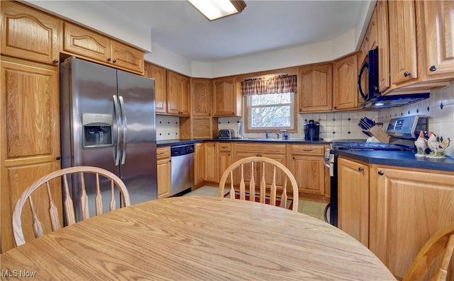 kitchen with stainless steel appliances, tasteful backsplash, and sink