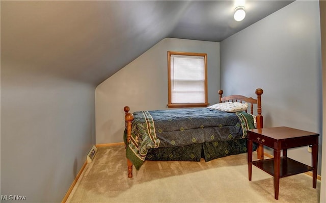 carpeted bedroom featuring vaulted ceiling