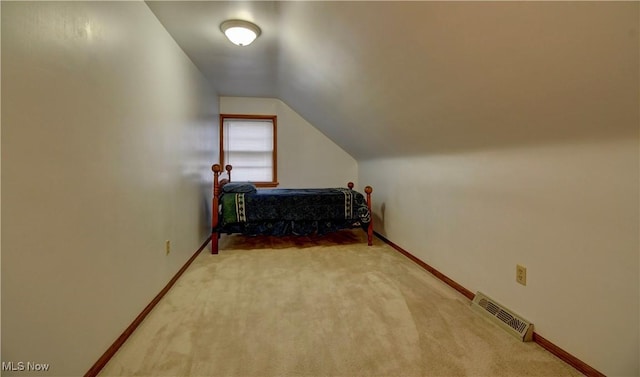 carpeted bedroom featuring lofted ceiling