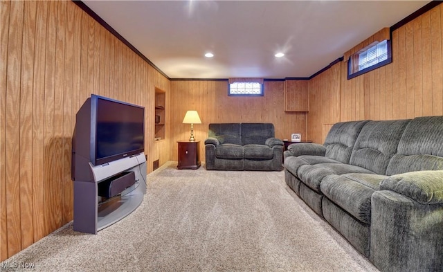 carpeted living room featuring crown molding and wood walls