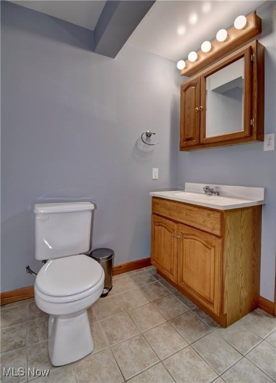 bathroom with tile patterned floors, vanity, and toilet