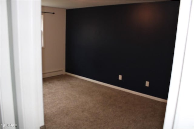 carpeted empty room with baseboard heating