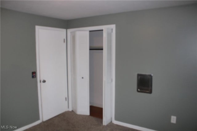 unfurnished bedroom featuring carpet floors and a closet