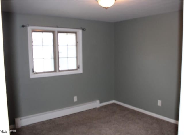 unfurnished room with carpet and a baseboard radiator