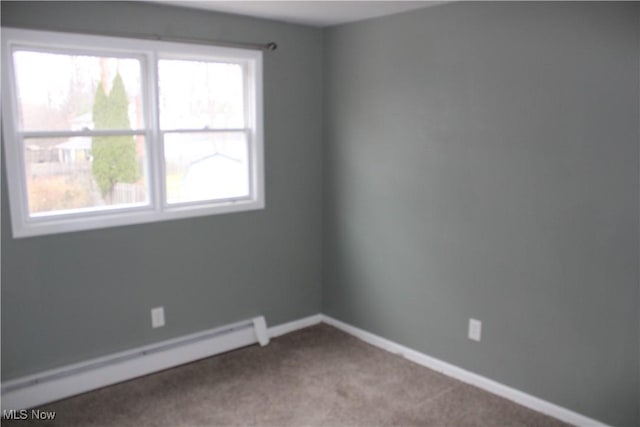 empty room with light carpet and baseboard heating