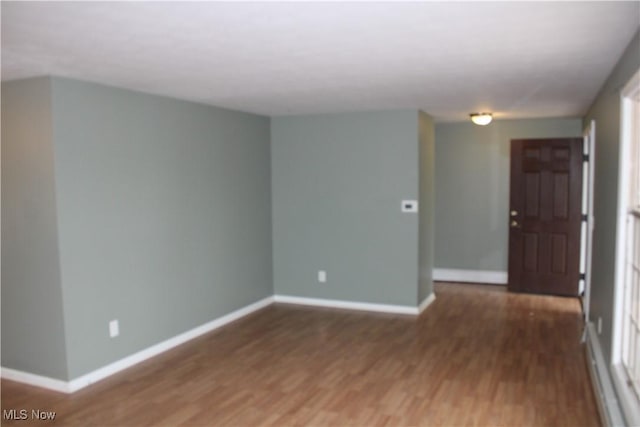 empty room featuring dark hardwood / wood-style flooring