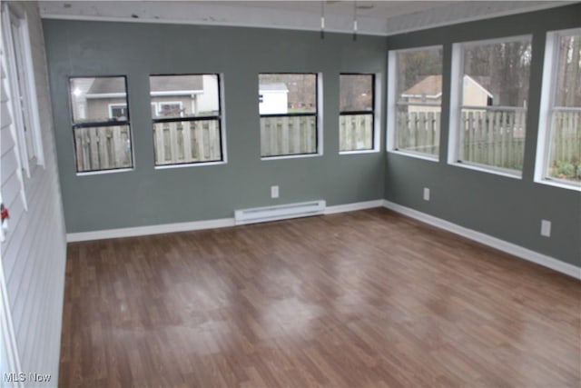 unfurnished sunroom with baseboard heating