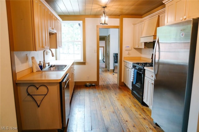 4101 Canfield Rd, Canfield, OH 44406 - kitchen with appliances with stainless steel finishes, light wood-type flooring, light countertops, decorative light fixtures, and custom exhaust hood