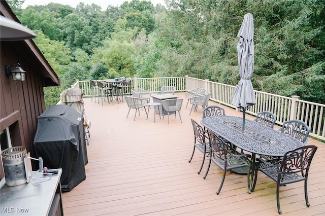 4101 Canfield Rd, Canfield, OH 44406 - deck featuring outdoor dining space, a forest view, and a grill