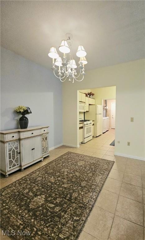 unfurnished dining area with light tile patterned floors and a notable chandelier