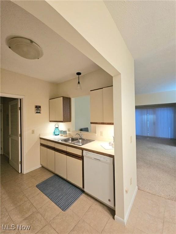 kitchen featuring white dishwasher, light colored carpet, and sink