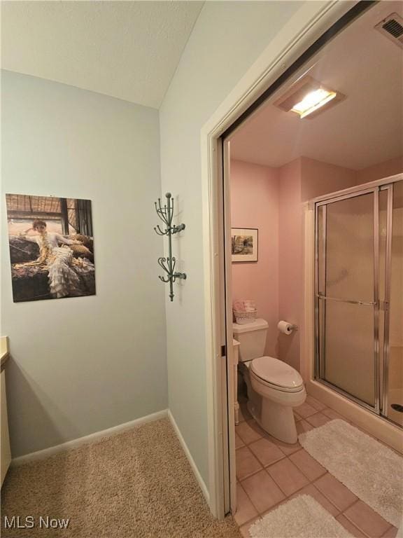 bathroom with tile patterned flooring, toilet, an enclosed shower, and vanity