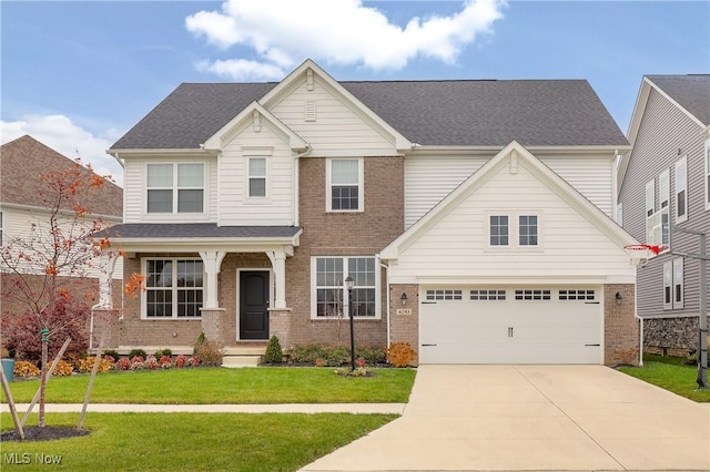 craftsman-style house featuring a front yard and a garage