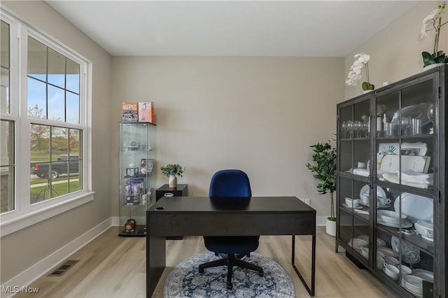 office space with light wood-type flooring