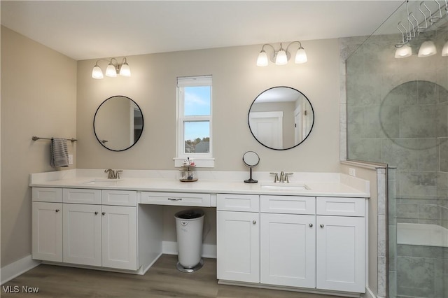 bathroom with vanity, hardwood / wood-style flooring, and a shower with shower door