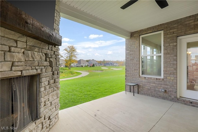 view of patio / terrace featuring an outdoor stone fireplace