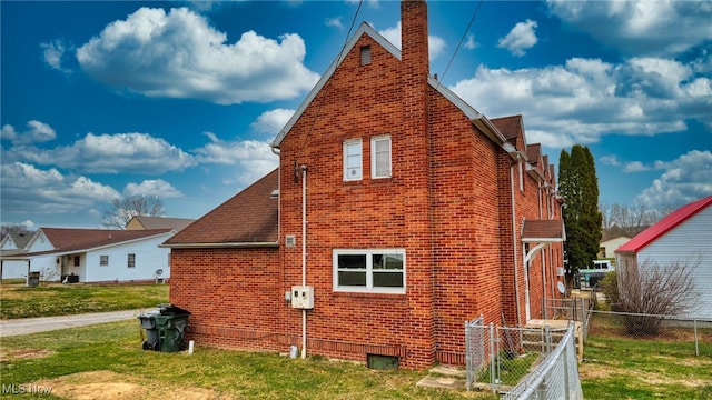 view of side of property with a lawn