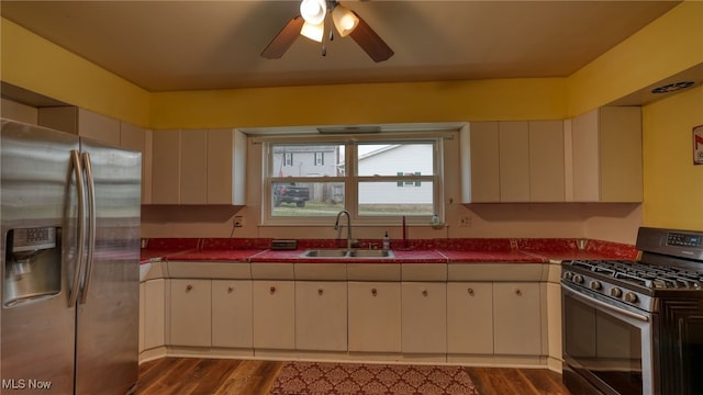 kitchen with ceiling fan, dark hardwood / wood-style flooring, sink, and appliances with stainless steel finishes