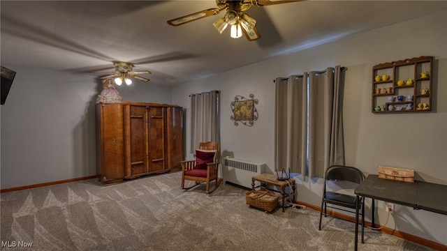 sitting room featuring carpet, ceiling fan, and radiator heating unit