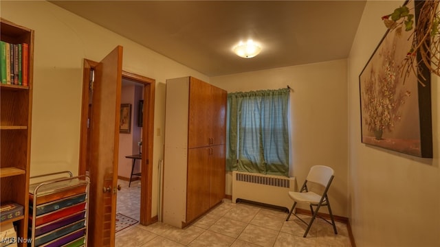 living area with radiator heating unit and light tile patterned floors