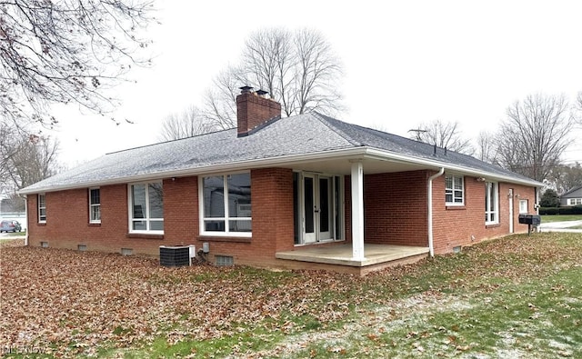 rear view of property with a patio area and central AC