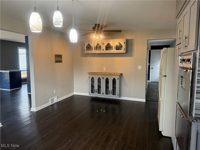 unfurnished living room featuring dark hardwood / wood-style floors and ceiling fan