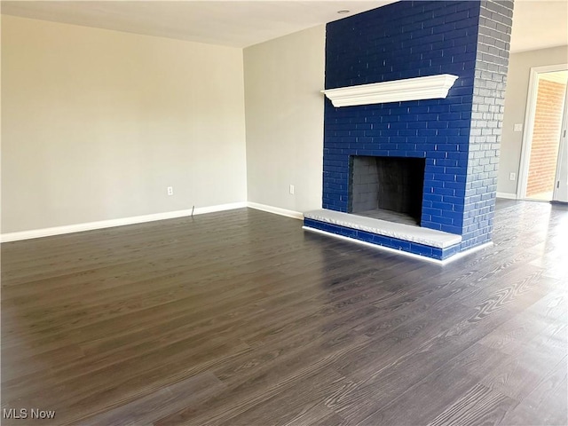 unfurnished living room featuring a fireplace and wood-type flooring