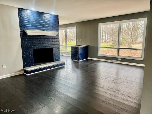 unfurnished living room with a fireplace and dark hardwood / wood-style flooring