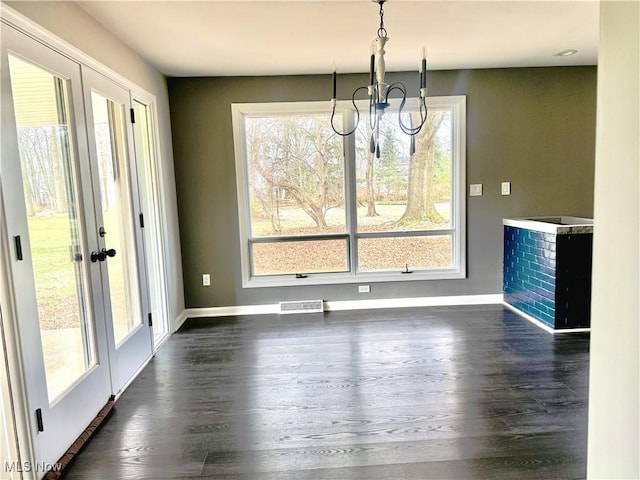 unfurnished dining area featuring dark hardwood / wood-style floors