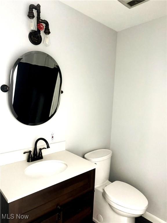 bathroom featuring vanity and toilet