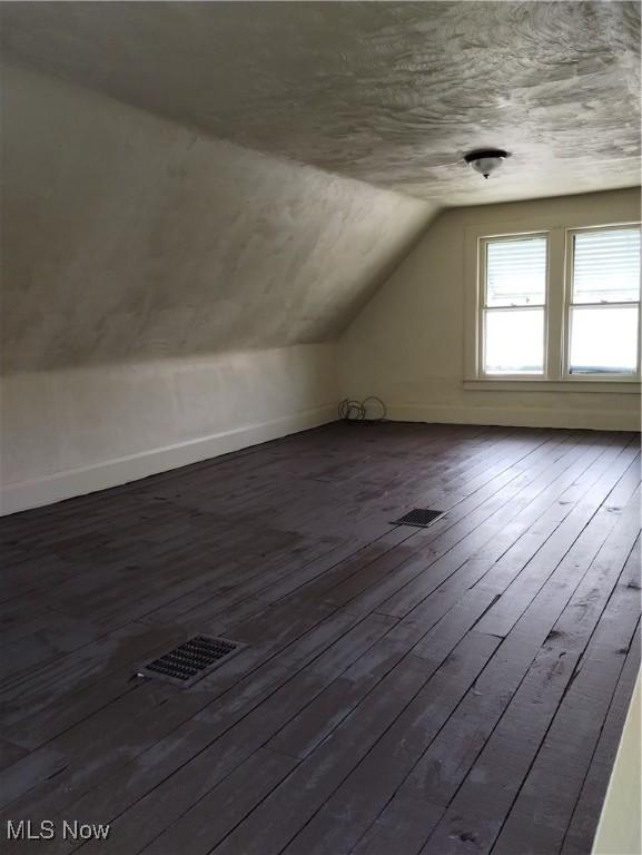 bonus room featuring hardwood / wood-style flooring and lofted ceiling