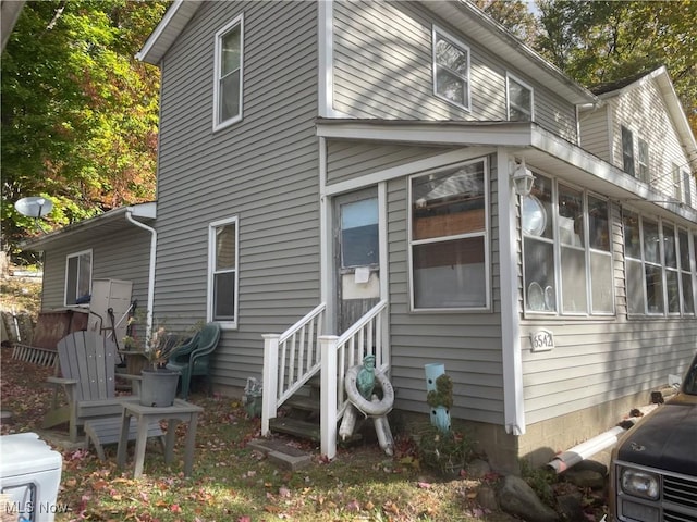 rear view of property with a sunroom