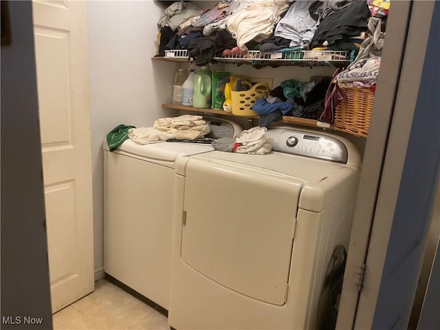 laundry area featuring independent washer and dryer and light tile patterned floors