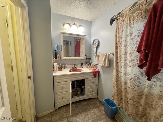 bathroom with vanity and a textured ceiling