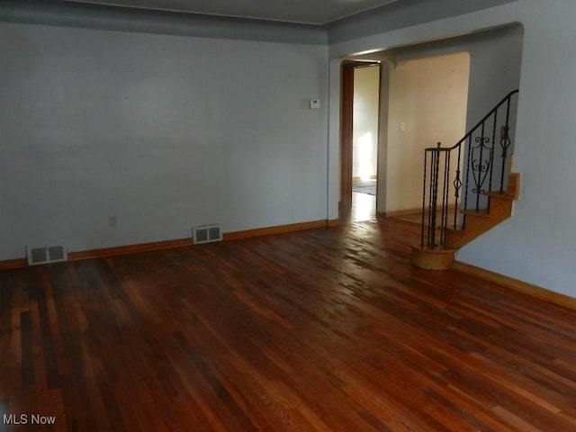 spare room featuring dark hardwood / wood-style floors