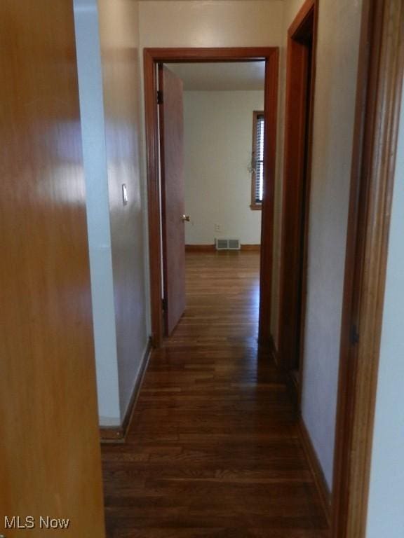 corridor featuring dark hardwood / wood-style floors