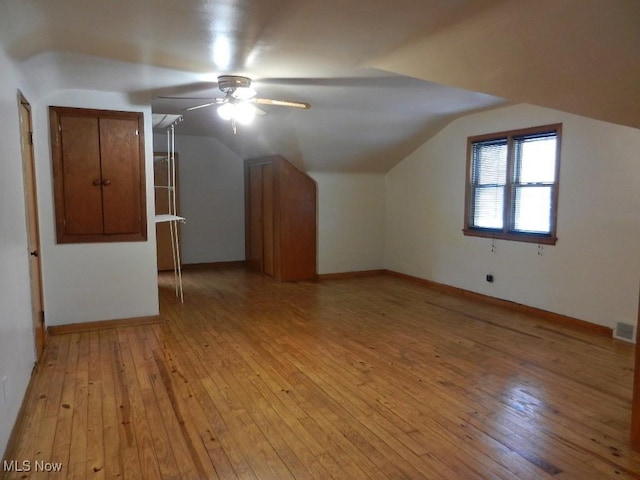 additional living space with ceiling fan, vaulted ceiling, and light hardwood / wood-style flooring