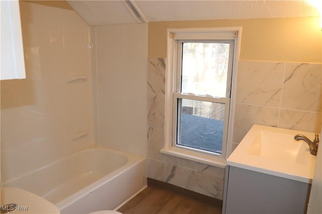 full bathroom with vanity, toilet, wood-type flooring, and tile walls