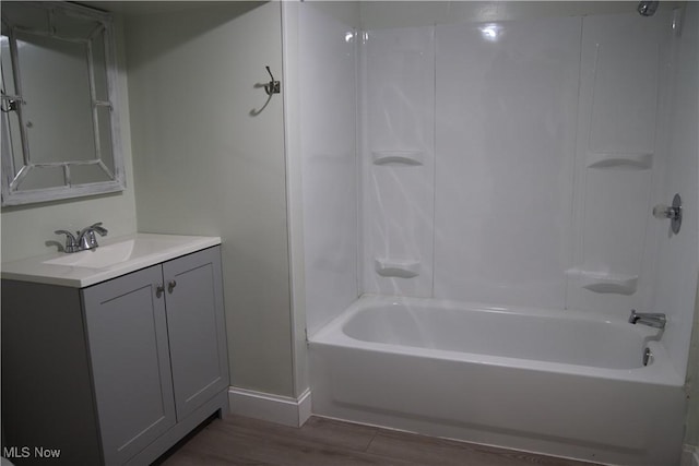 bathroom featuring hardwood / wood-style floors, vanity, and shower / bathtub combination