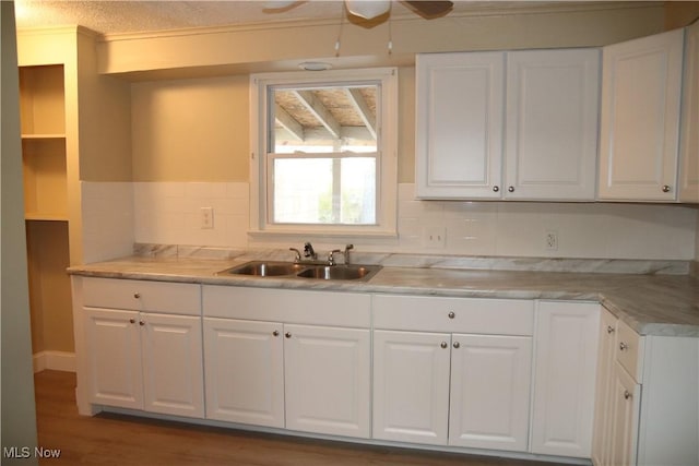 kitchen featuring a textured ceiling, white cabinetry, sink, and dark hardwood / wood-style floors