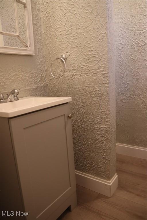 bathroom featuring vanity and hardwood / wood-style flooring