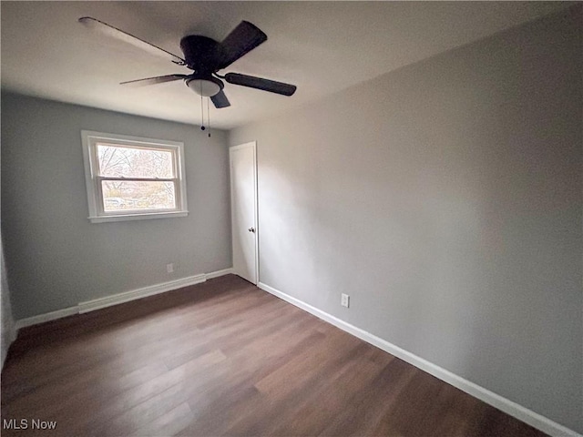 spare room with ceiling fan and wood-type flooring