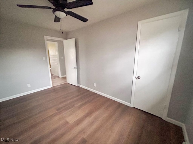 unfurnished bedroom with ceiling fan and wood-type flooring