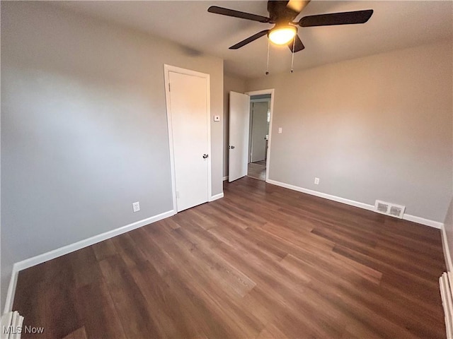 spare room with dark hardwood / wood-style floors and ceiling fan