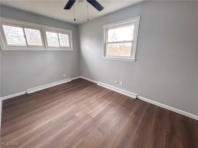 unfurnished room featuring ceiling fan, baseboard heating, and dark wood-type flooring