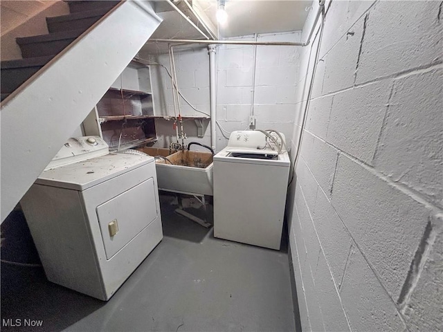 clothes washing area featuring sink and washer and dryer