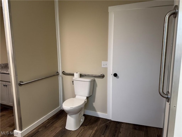 bathroom with hardwood / wood-style floors, vanity, and toilet