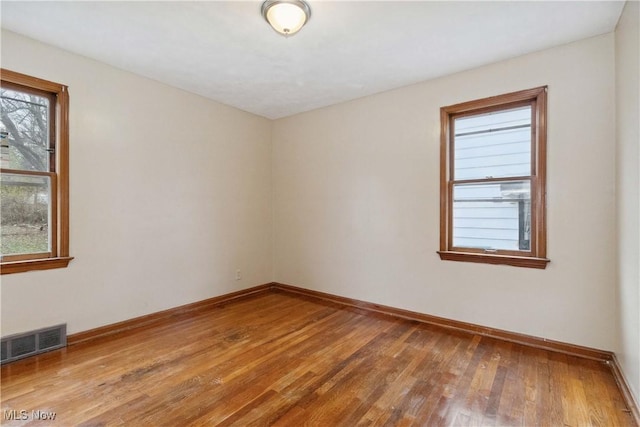 empty room with hardwood / wood-style flooring